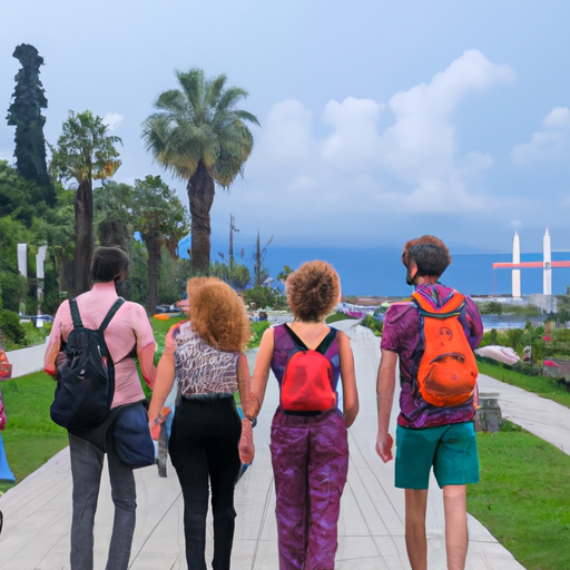 קבוצת תיירים ישראלים חוקרת את שדרות בטומי היפות עם הים השחור ברקע.