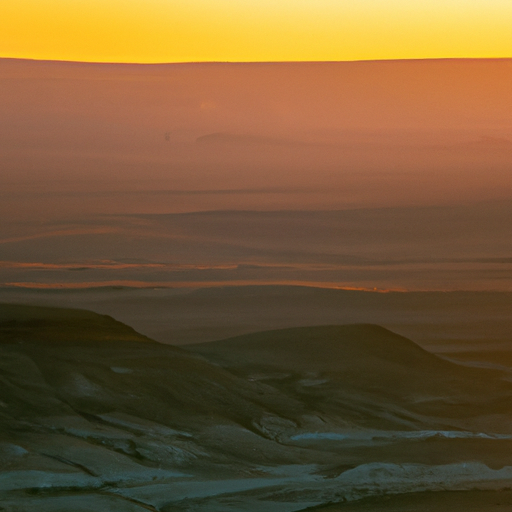 A panoramic view of the expansive Negev desert with the setting sun casting golden hues.