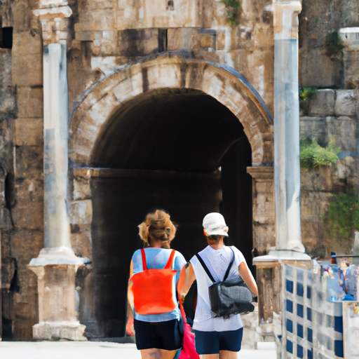 תיירים המבקרים בשער אדריאנוס העתיק, ציון דרך מפורסם באנטליה